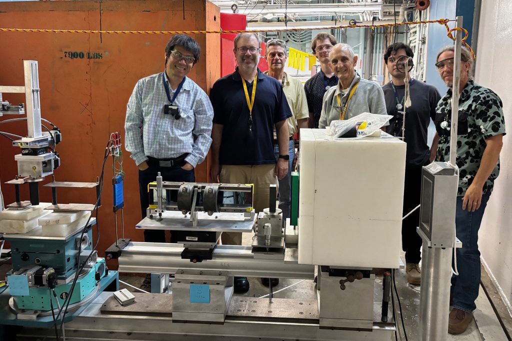 a group photo in front of the GANS reflectometer