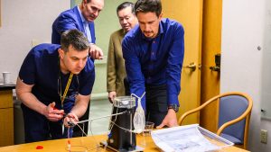 A doctor practices dosing on a delivery device for microspheres