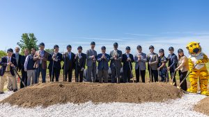 A group poses with shovels at the Radioisotope Science Center Groundbreaking at Discovery Ridge in Columbia, Mo.